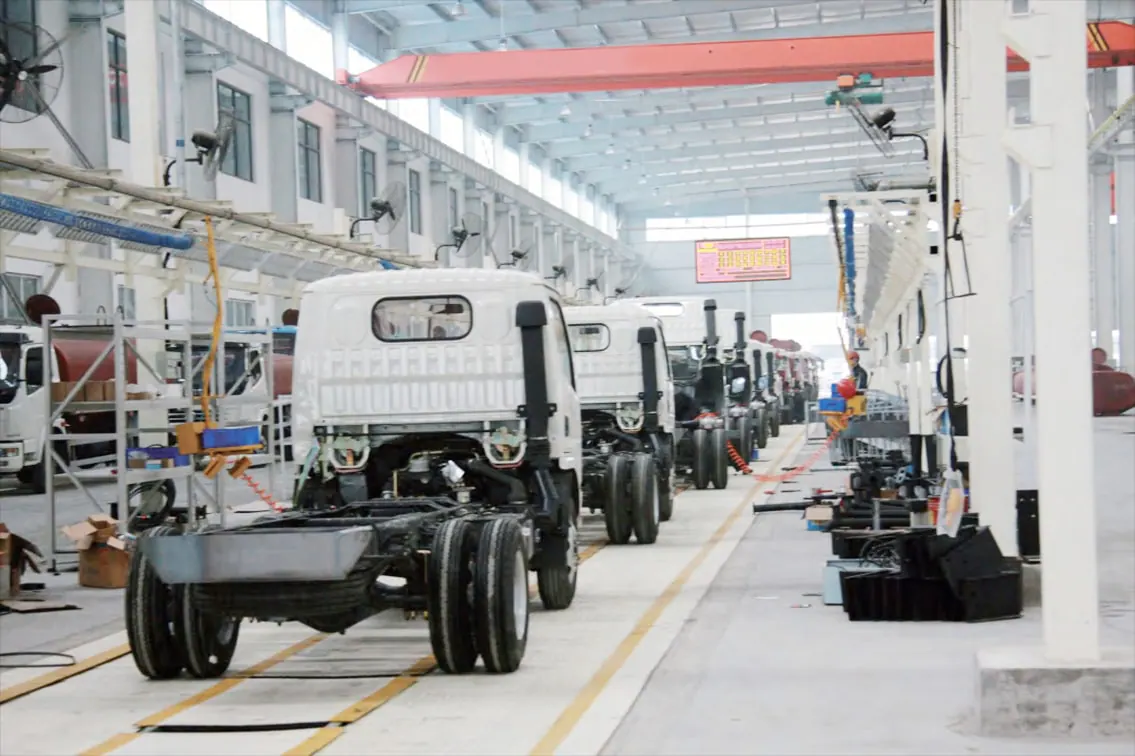 Truck chassis moving through the KEEYAK factory configuration line